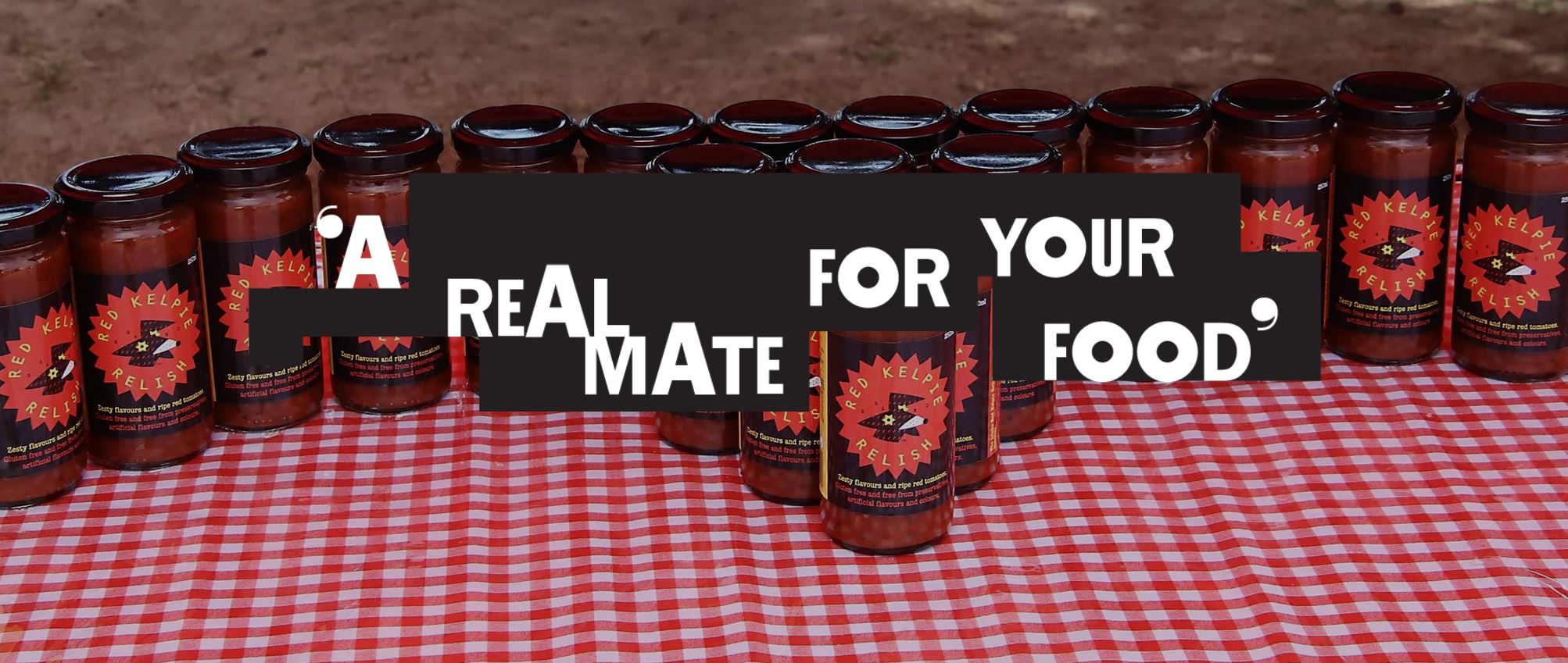 Red Kelpie Relish jars on a red gingham picnic blanket. Tagline: A real mate for your food.